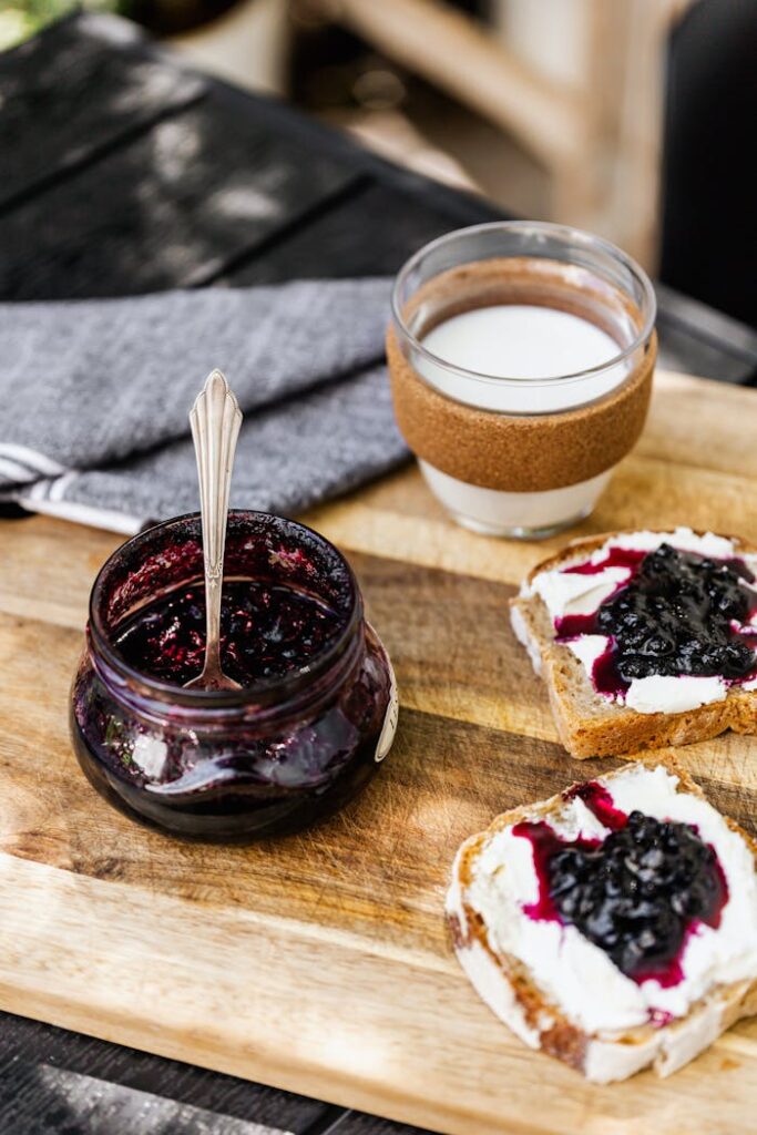 Delicious rustic breakfast with blueberry jam, toast, and milk for a perfect start to your day.