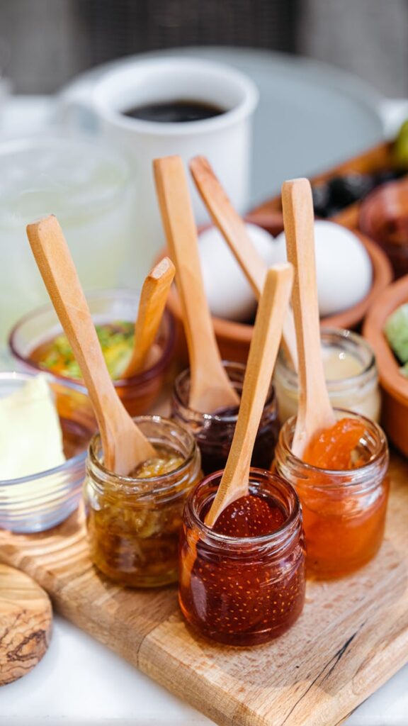 Assorted homemade jams in rustic jars perfect for breakfast spread. Fresh and tasty.